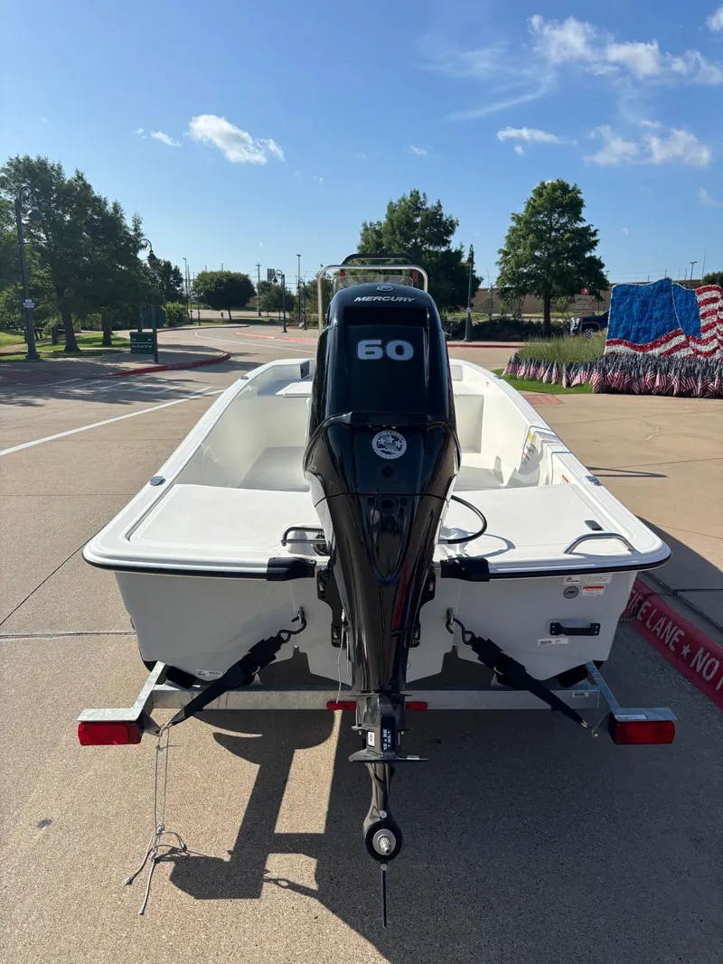 Slide: The Image of 2025 Mako Pro Skiff 15 CC with Mercury 60 engine on trailer. - 3