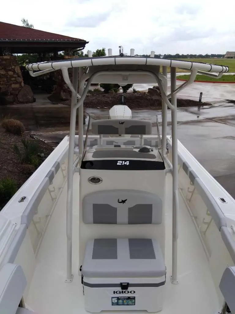 Slide: The Image of 2025 Mako 214 CC boat with T-top and Igloo cooler on deck. - 3
