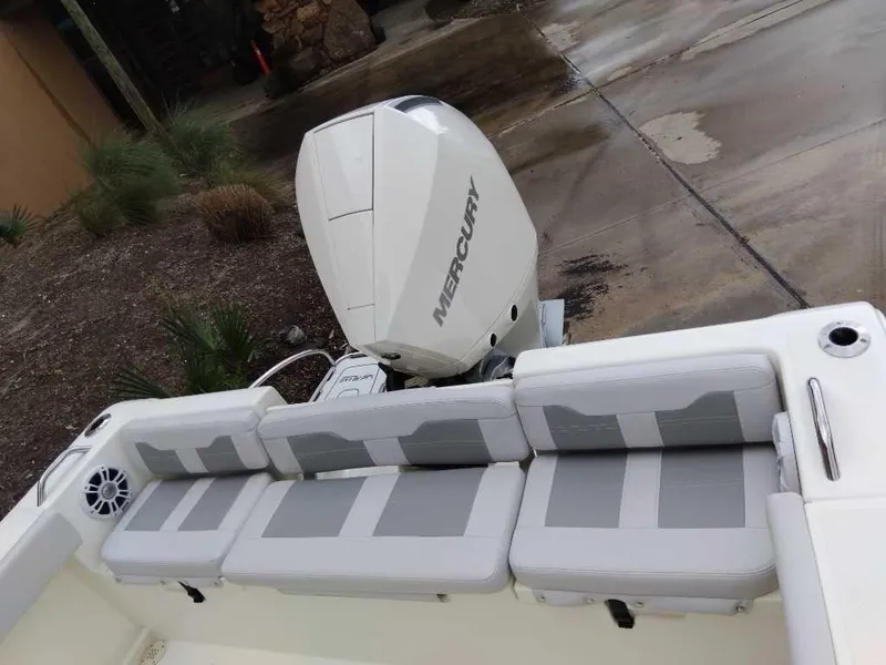 Slide: The Image of 2025 Mako 214 CC boat with Mercury engine and cushioned seating. - 4