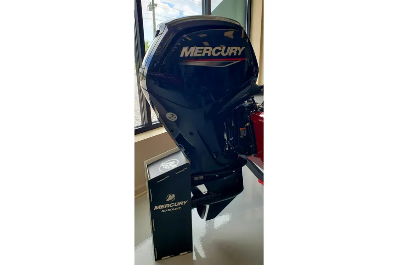 Slide: The Image of Mercury outboard motor displayed indoors, next to Tracker Pro Team 175, 2025 model. - 2