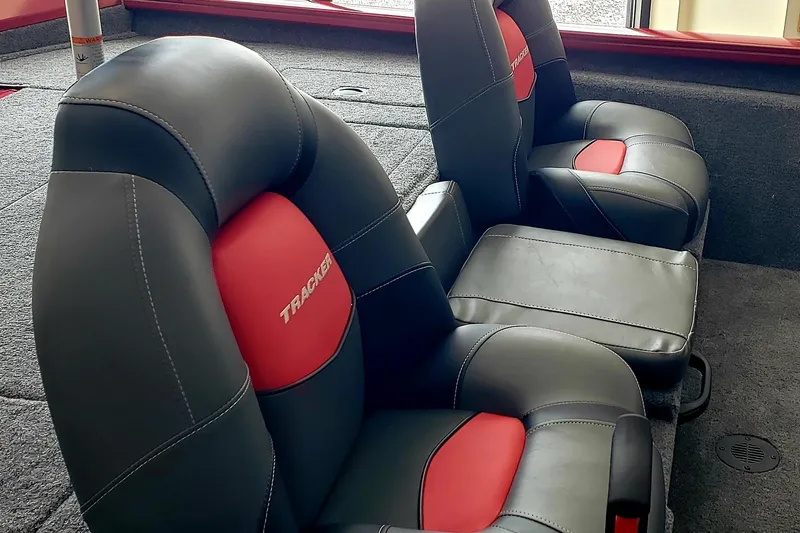 Slide: The Image of 2025 Tracker Pro Team 175 boat seats, black and red upholstery, interior view. - 5