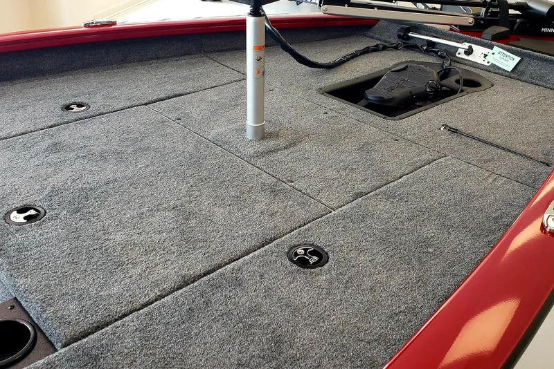 Slide: The Image of 2025 Tracker Pro Team 175 boat deck with gray carpet and red trim. - 6
