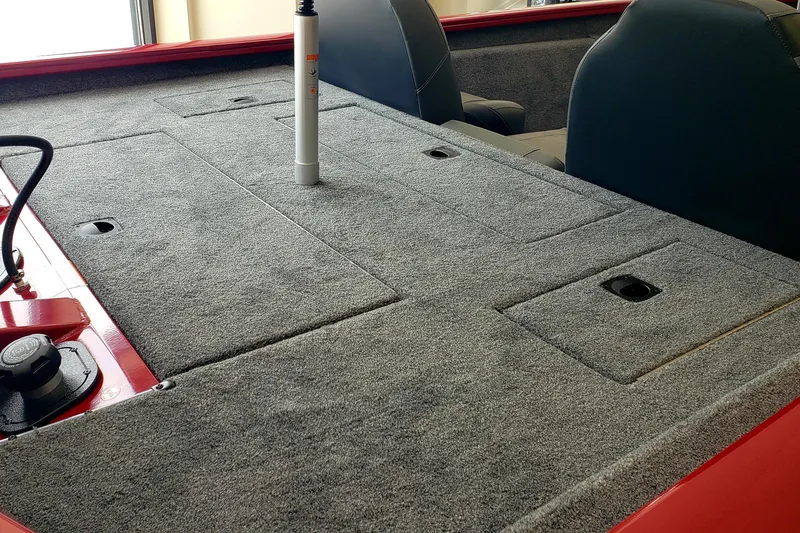 Slide: The Image of 2025 Tracker Pro Team 175 boat interior with gray carpeted deck and seating. - 7