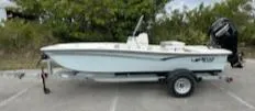The Image of 2025 Mako Pro Skiff 15 CC boat on trailer, parked outdoors. - 0