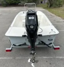 Slide: The Image of 2025 Mako Pro Skiff 15 CC boat with outboard motor on trailer. - 11