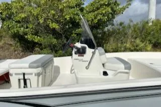 Slide: The Image of 2025 Mako Pro Skiff 15 CC boat with console and seating, surrounded by greenery. - 7