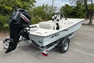 Slide: The Image of 2025 Mako Pro Skiff 15 CC boat on trailer with Mercury outboard motor. - 8