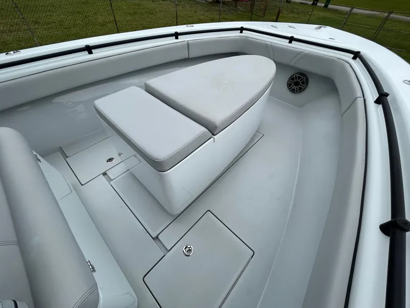 Slide: The Image of 2024 Contender 28 Tournament boat interior with cushioned seating and storage compartments. - 12