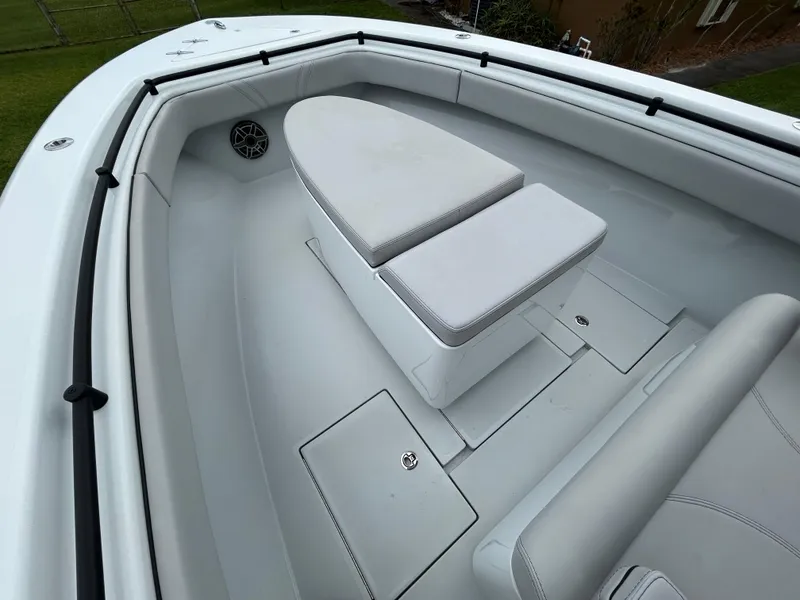 Slide: The Image of 2024 Contender 28 Tournament boat interior with cushioned seating and storage compartments. - 13