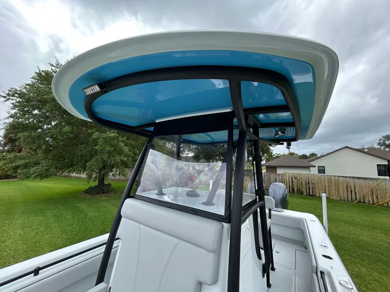 Slide: The Image of 2024 Contender 28 Tournament boat with blue T-top and sleek design. - 18