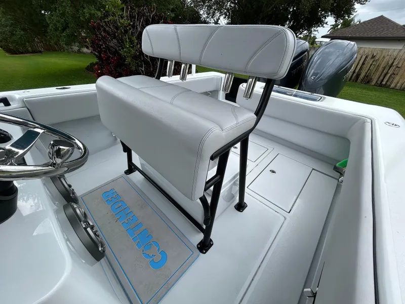 Slide: The Image of 2024 Contender 28 Tournament boat interior with white seating and steering wheel. - 19