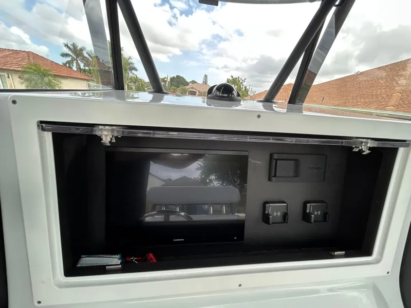 Slide: The Image of 2024 Contender 28 Tournament boat dashboard with electronic display and controls. - 27