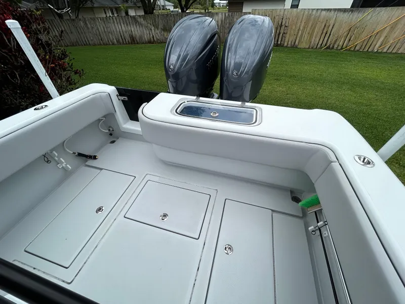 Slide: The Image of 2024 Contender 28 Tournament boat deck with dual outboard motors, spacious storage, and sleek design. - 29