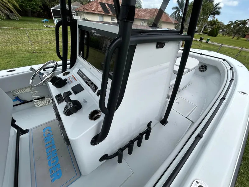 Slide: The Image of 2024 Contender 28 Tournament boat console with controls and steering wheel. - 32