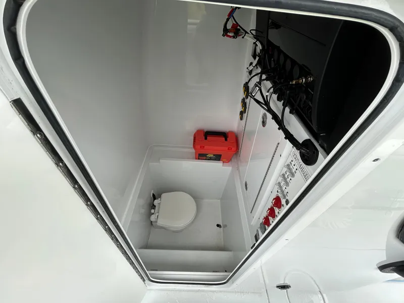 Slide: The Image of 2024 Contender 28 Tournament boat interior with toilet and wiring panel. - 33