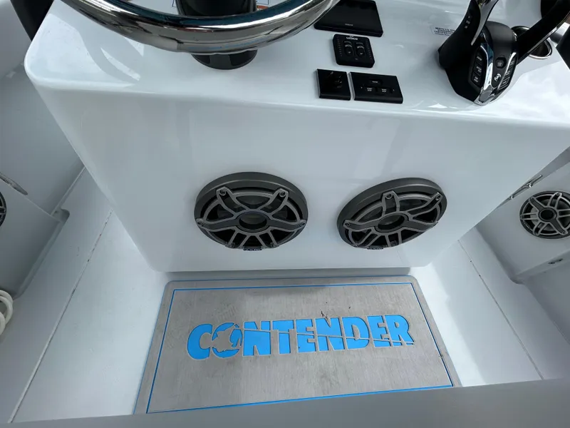 Slide: The Image of 2024 Contender 28 Tournament boat console with speakers and branded mat. - 34