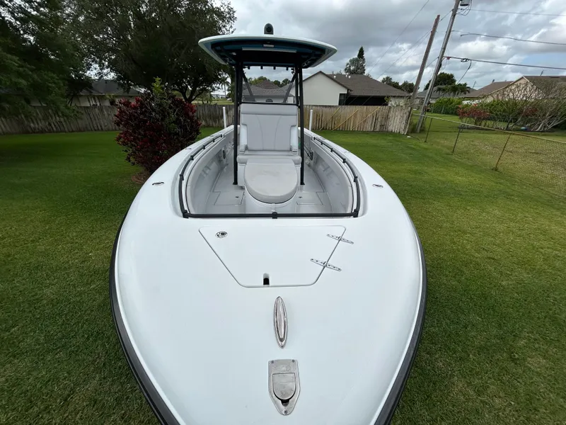 Slide: The Image of 2024 Contender 28 Tournament boat on grass, showcasing sleek design and spacious deck. - 6