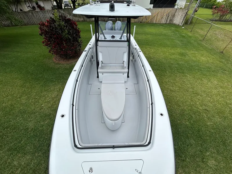Slide: The Image of 2024 Contender 28 Tournament boat on grass, showcasing sleek design and spacious deck. - 9