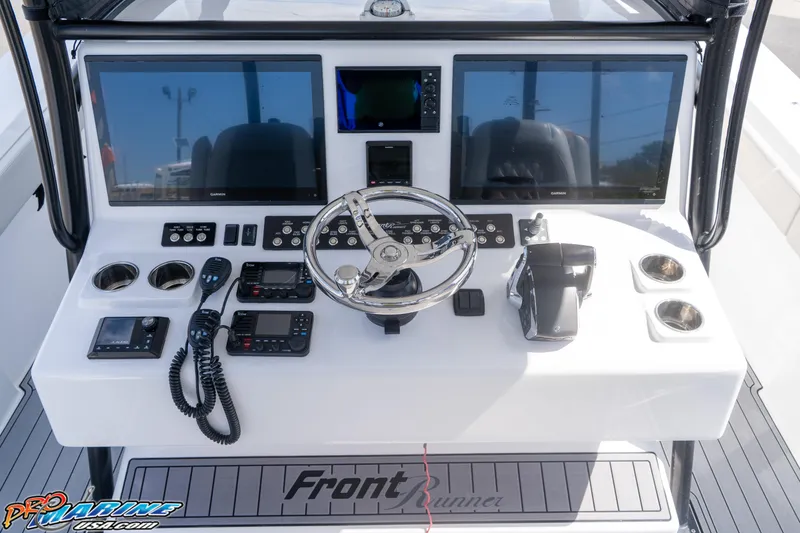 Slide: The Image of 2023 Front Runner 39 Center Console boat dashboard with dual screens and controls. - 13