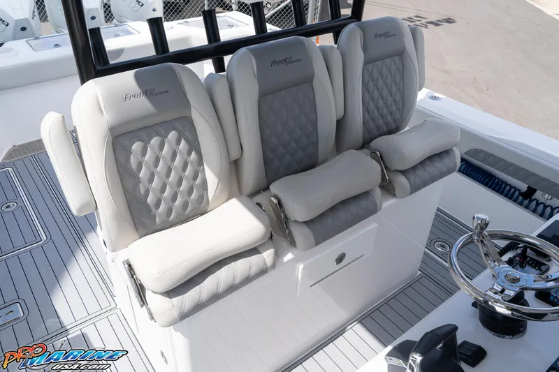 Slide: The Image of 2023 Front Runner 39 Center Console boat seats with diamond-stitched upholstery and helm station. - 15