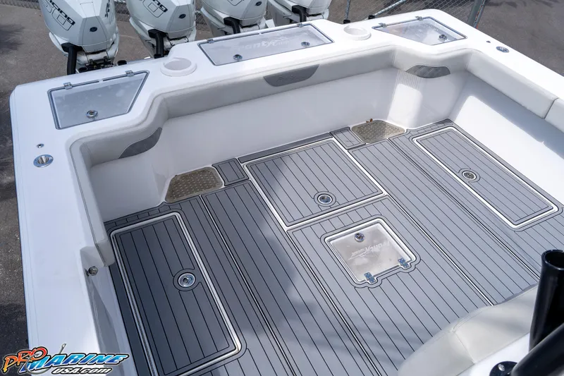 Slide: The Image of 2023 Front Runner 39 Center Console boat deck with storage compartments and outboard motors. - 25