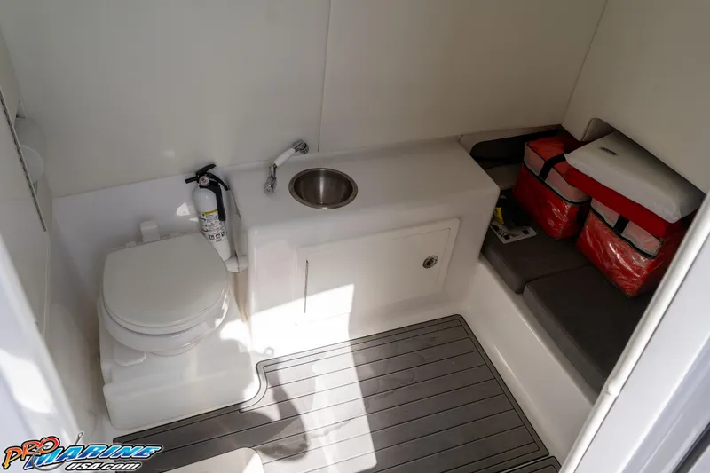 Slide: The Image of 2023 Front Runner 39 Center Console boat interior with toilet, sink, and storage area. - 26