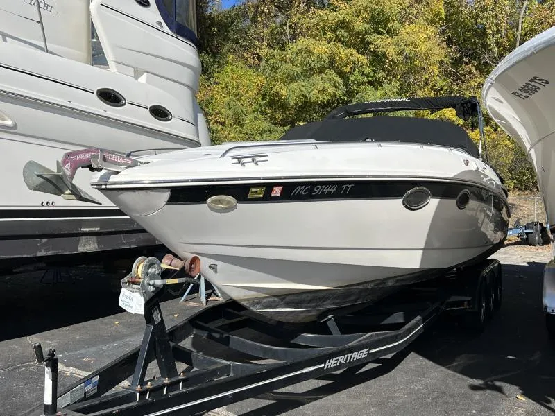 Slide: The Image of 2001 Chaparral 285 SSi boat on trailer, parked outdoors with trees in background. - 1