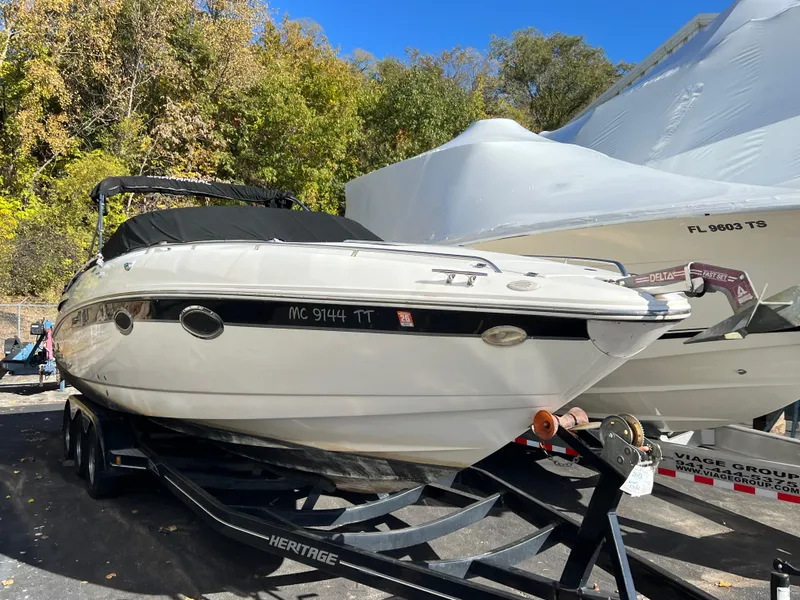 Slide: The Image of 2001 Chaparral 285 SSi boat on trailer, parked outdoors with trees in background. - 9