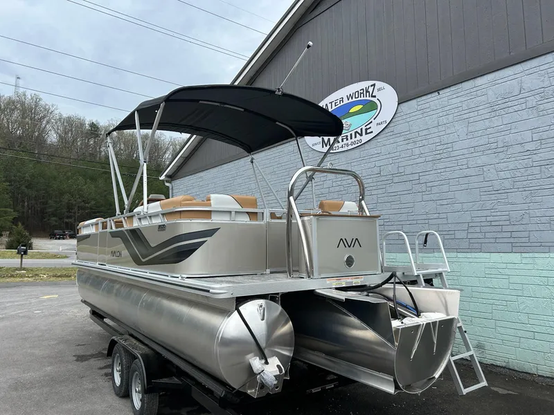 Slide: The Image of 2025 Avalon 2380 Venture Quad Lounger pontoon boat on trailer, parked outside marine shop. - 4