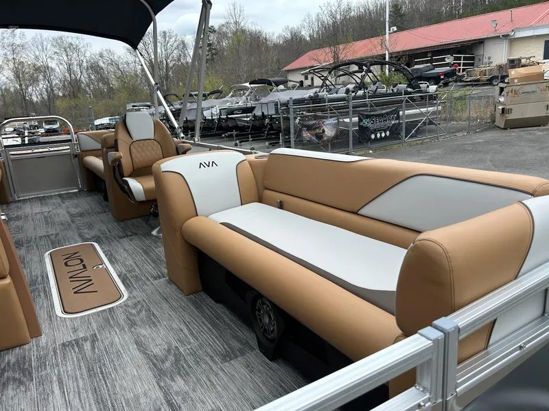 Slide: The Image of 2025 Avalon 2380 Venture Quad Lounger with tan and white seating, docked outdoors. - 5