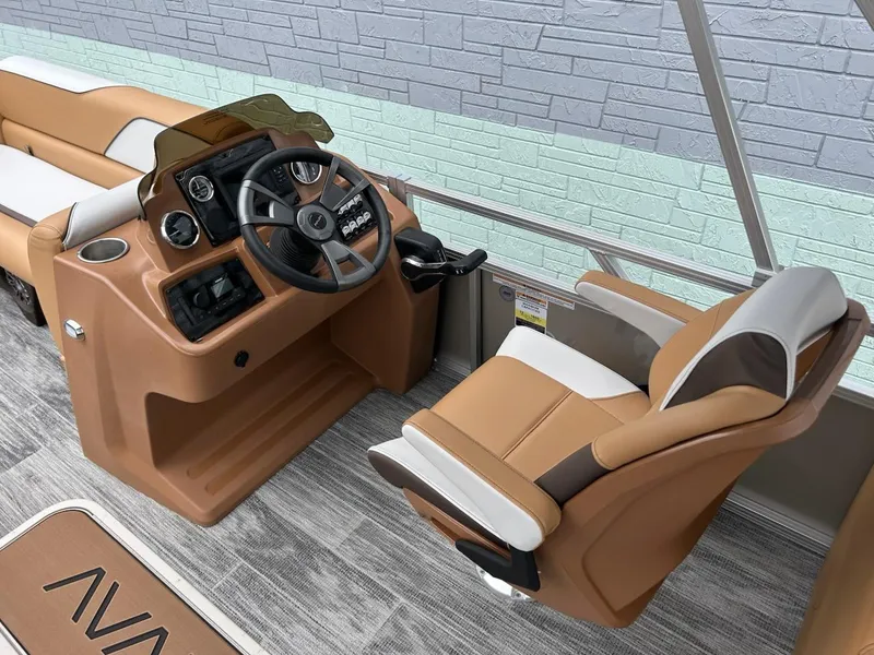 Slide: The Image of 2025 Avalon 2380 Venture Quad Lounger boat interior with tan and white seating, modern helm controls. - 8