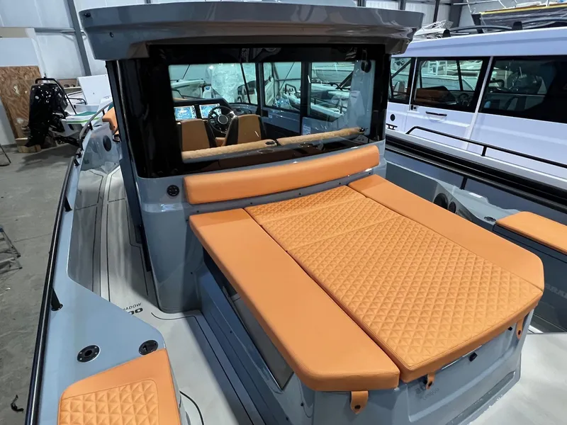 Slide: The Image of 2022 BRABUS Shadow 500 Cabin with orange seating, sleek design, and modern interior. - 13