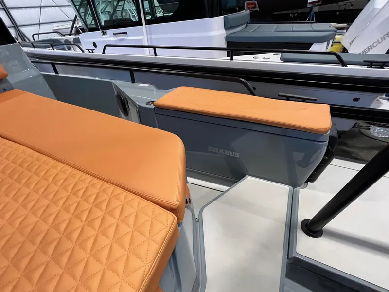 Slide: The Image of 2022 BRABUS Shadow 500 Cabin with orange quilted seating and sleek design. - 15