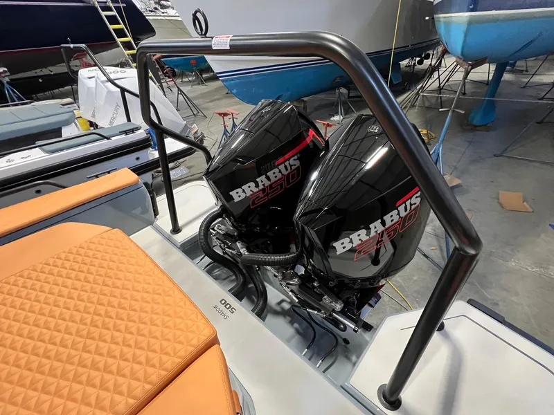 Slide: The Image of 2022 BRABUS Shadow 500 Cabin with dual outboard engines in a boatyard setting. - 16