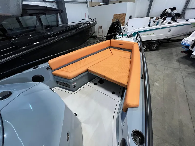 Slide: The Image of 2022 BRABUS Shadow 500 Cabin boat with orange seating in a showroom. - 22