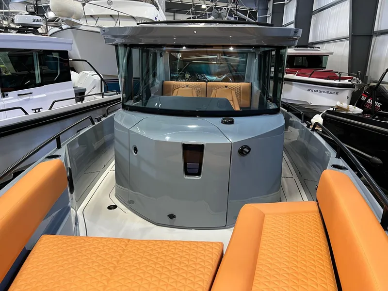 Slide: The Image of 2022 BRABUS Shadow 500 Cabin with orange seating, sleek design, and modern cabin interior. - 24