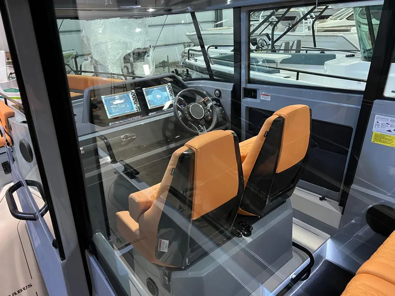 Slide: The Image of 2022 BRABUS Shadow 500 Cabin interior with orange seats and modern dashboard. - 30