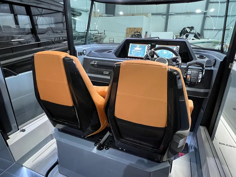 Slide: The Image of 2022 BRABUS Shadow 500 Cabin interior with dual orange seats and modern dashboard. - 33