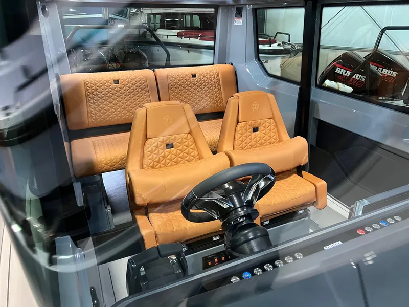 Slide: The Image of 2022 BRABUS Shadow 500 Cabin interior with luxurious tan leather seating and modern steering wheel. - 35