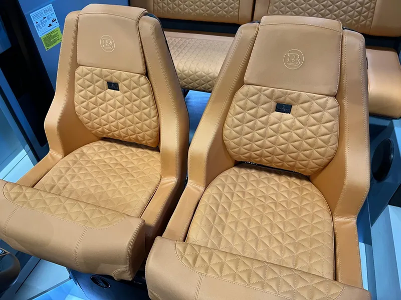 Slide: The Image of Luxurious tan leather seats in a 2022 BRABUS Shadow 500 Cabin boat. - 40