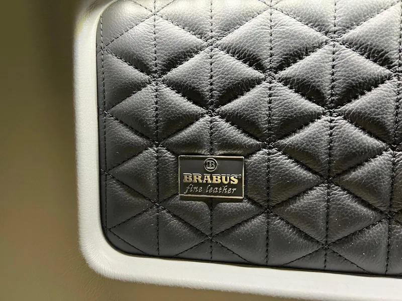 Slide: The Image of Quilted black leather interior of 2022 BRABUS Shadow 500 Cabin with logo. - 48