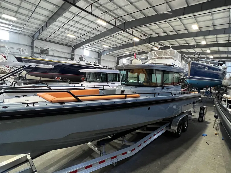 Slide: The Image of 2022 BRABUS Shadow 500 Cabin boat in a showroom, featuring sleek design and orange seating. - 5