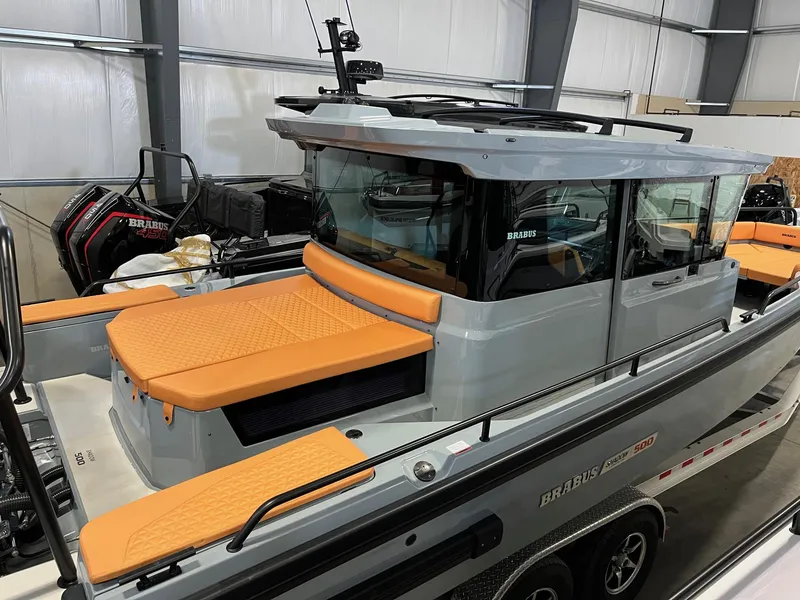 Slide: The Image of 2022 BRABUS Shadow 500 Cabin boat with orange seating in a showroom. - 9