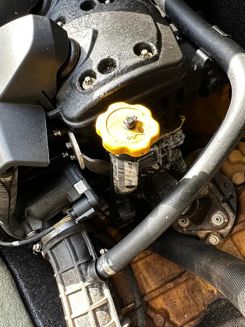 Slide: The Image of 2012 Sea-Doo GTX 155 engine close-up with visible components and yellow cap. - 11