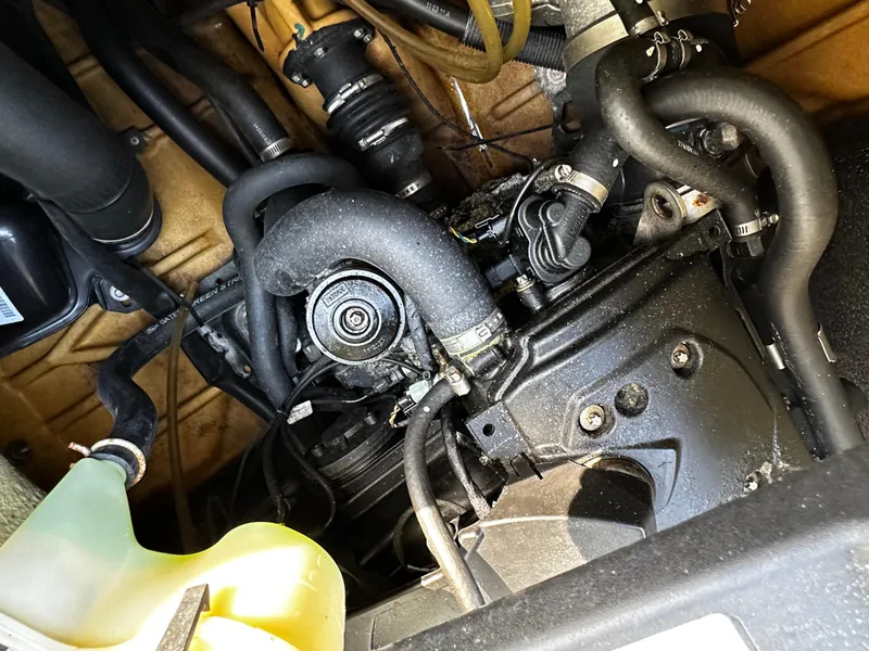 Slide: The Image of Engine compartment of a 2012 Sea-Doo GTX 155, showcasing hoses and mechanical components. - 12