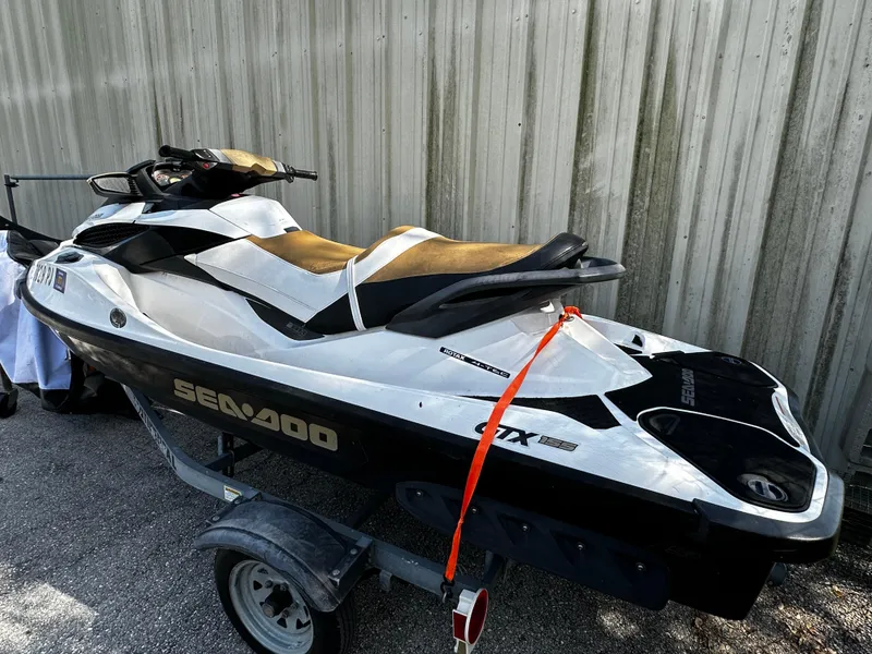 Slide: The Image of 2012 Sea-Doo GTX 155 jet ski on trailer, parked outdoors. - 3