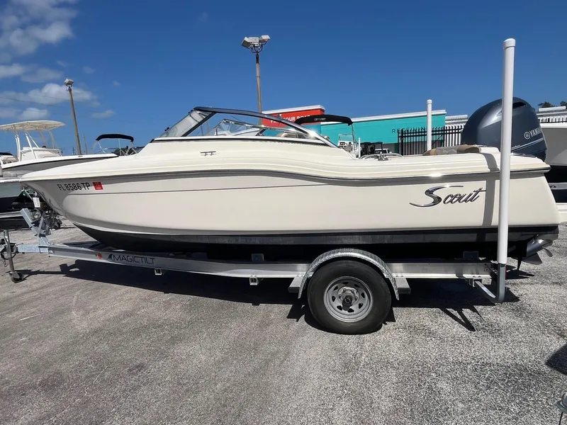 Slide: The Image of 2018 Scout 210 Dorado boat on trailer under clear blue sky. - 2