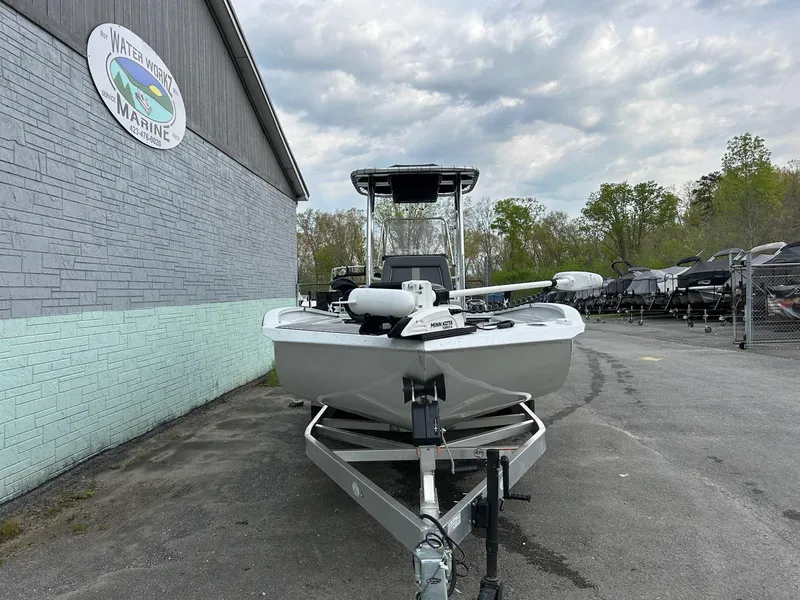 Slide: The Image of 2024 Express X23 Bay Lounge boat on trailer at marina, cloudy sky background. - 3