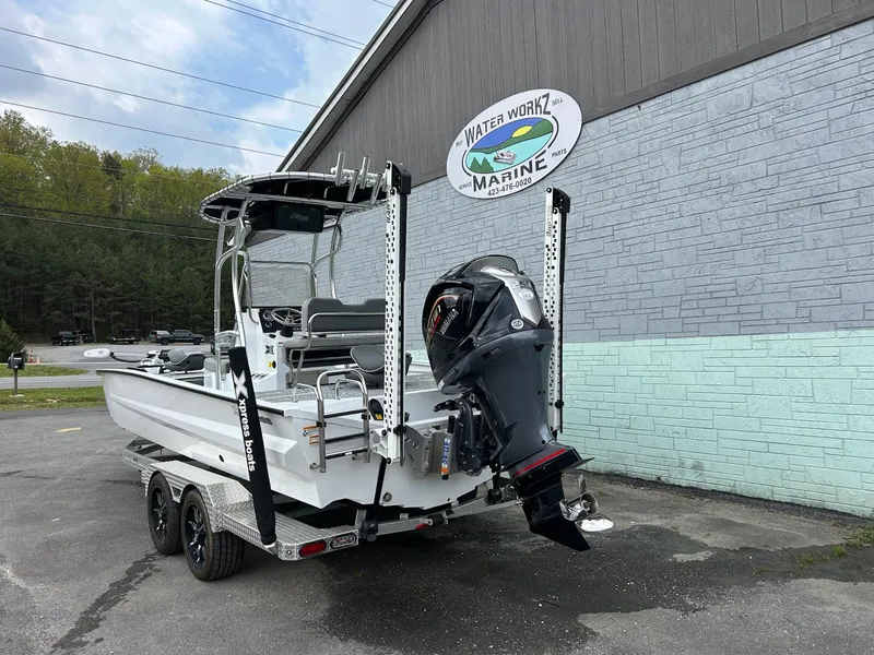 Slide: The Image of 2024 Express X23 Bay Lounge boat on trailer at Water Workz Marine dealership. - 4