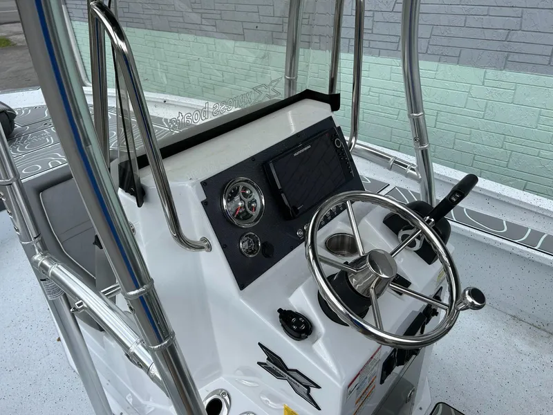 Slide: The Image of 2024 Express X23 Bay Lounge boat console with steering wheel and controls. - 7